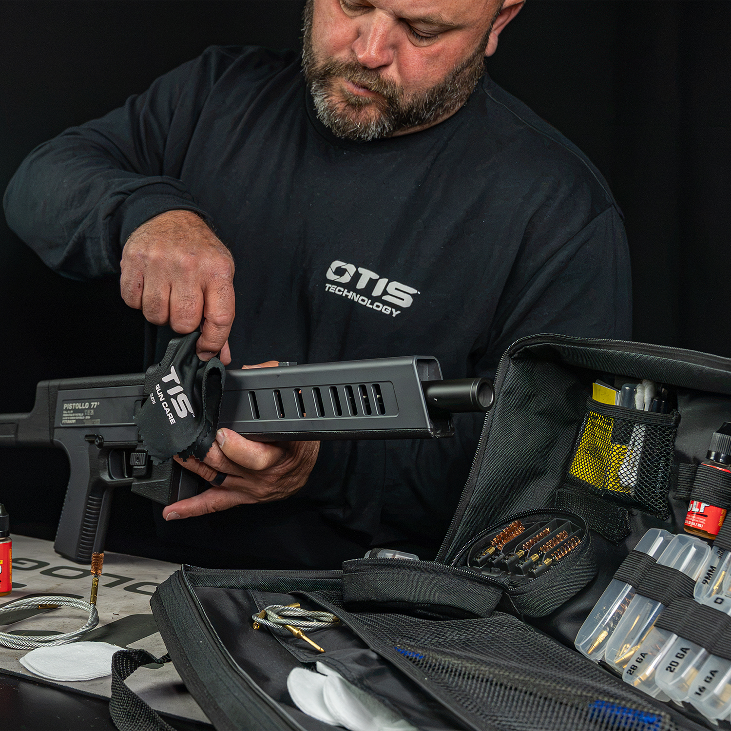 man from Otis cleaning firearms optic with lens cloth