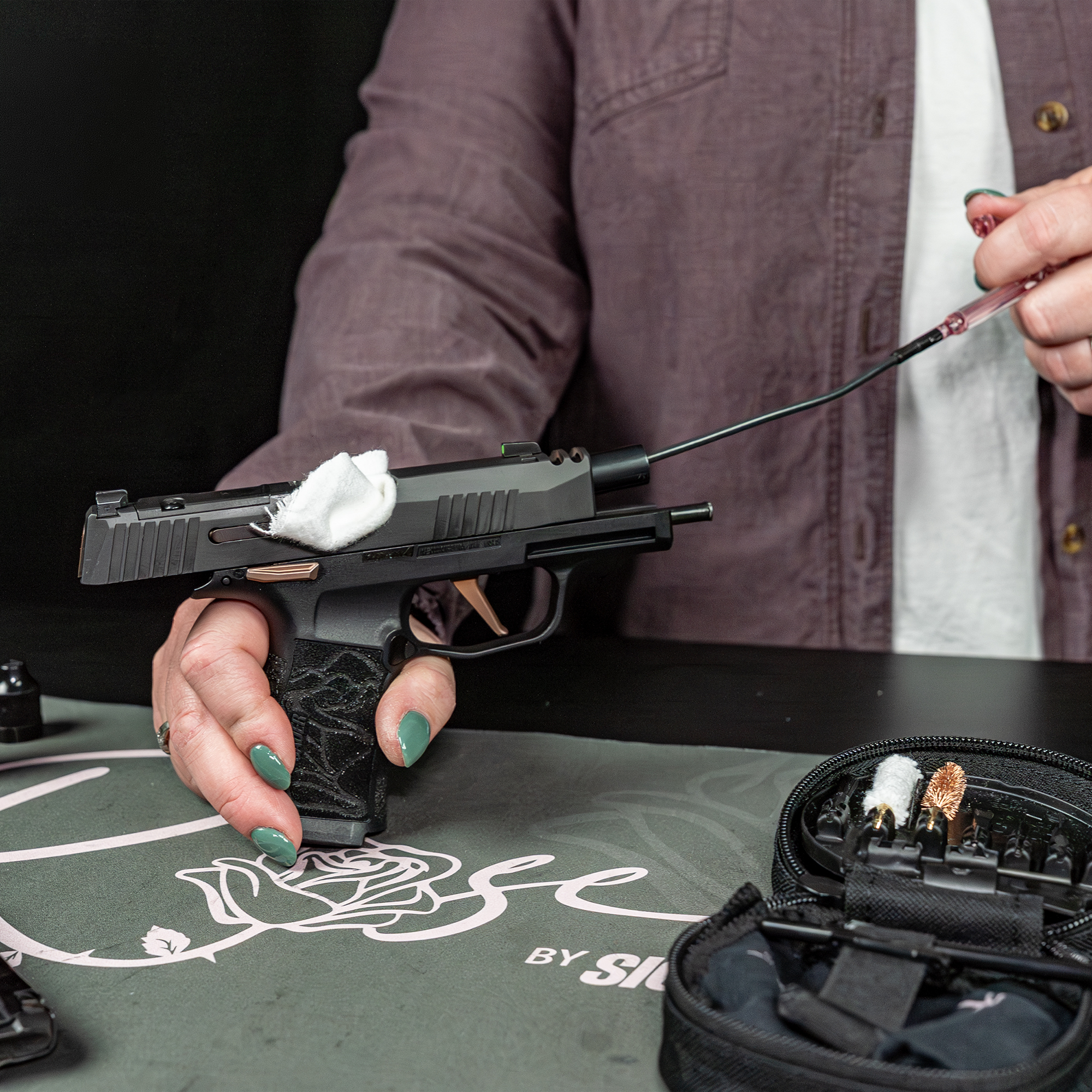 women cleaning a Rose by Sig Sauer p365 9mm comp using Otis Technology Rose by Sig Sauer Cleaning Kti